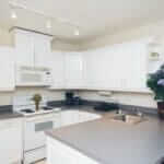 Kitchen with white cabinets in a Steps to Recovery drug rehab house