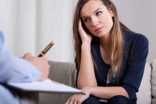 Worried young woman receiving alcohol counseling