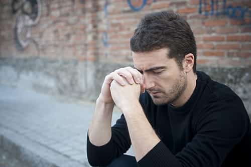 Man thinking about the best drug rehab centers.