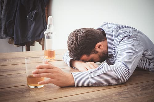 man is suffering from the mental effects of alcohol