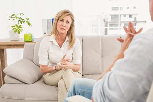 a middle aged woman takes part in substance abuse counseling