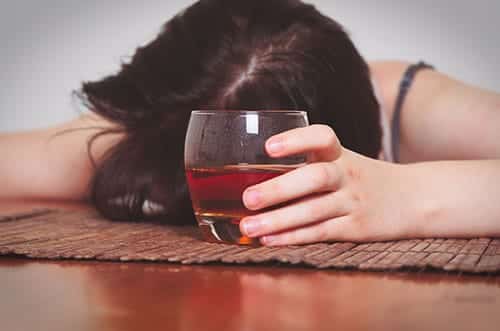 woman suffering from alcohol poisoning symptoms