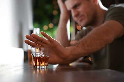 man is not sure how to quit drinking alcohol