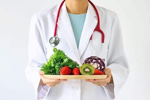 doctor with fruits and vegetables for Nutrition Education