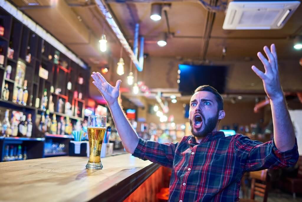 an angry drunk yelling at a bar