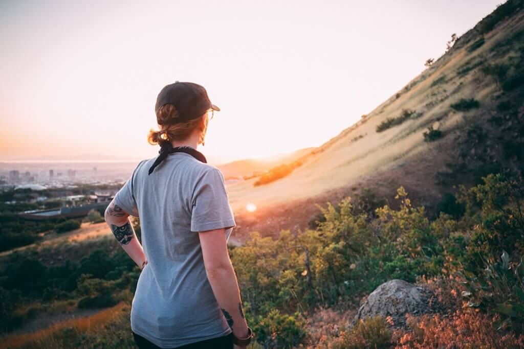 a woman hiking as a mindfulness based stress reduction