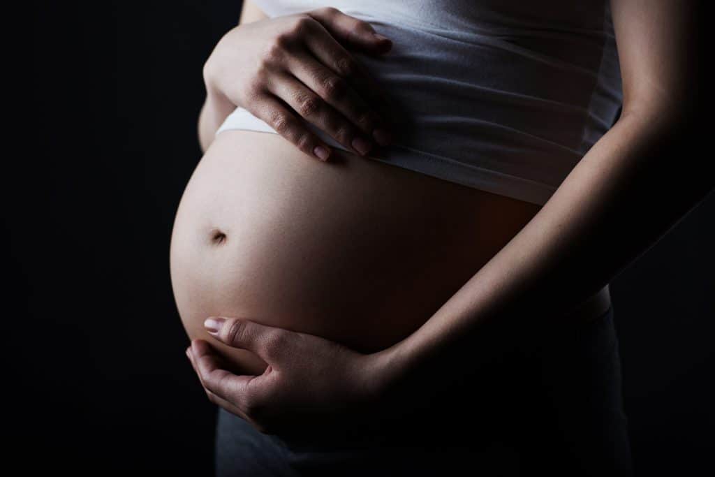 image of a pregnant woman holding her belly