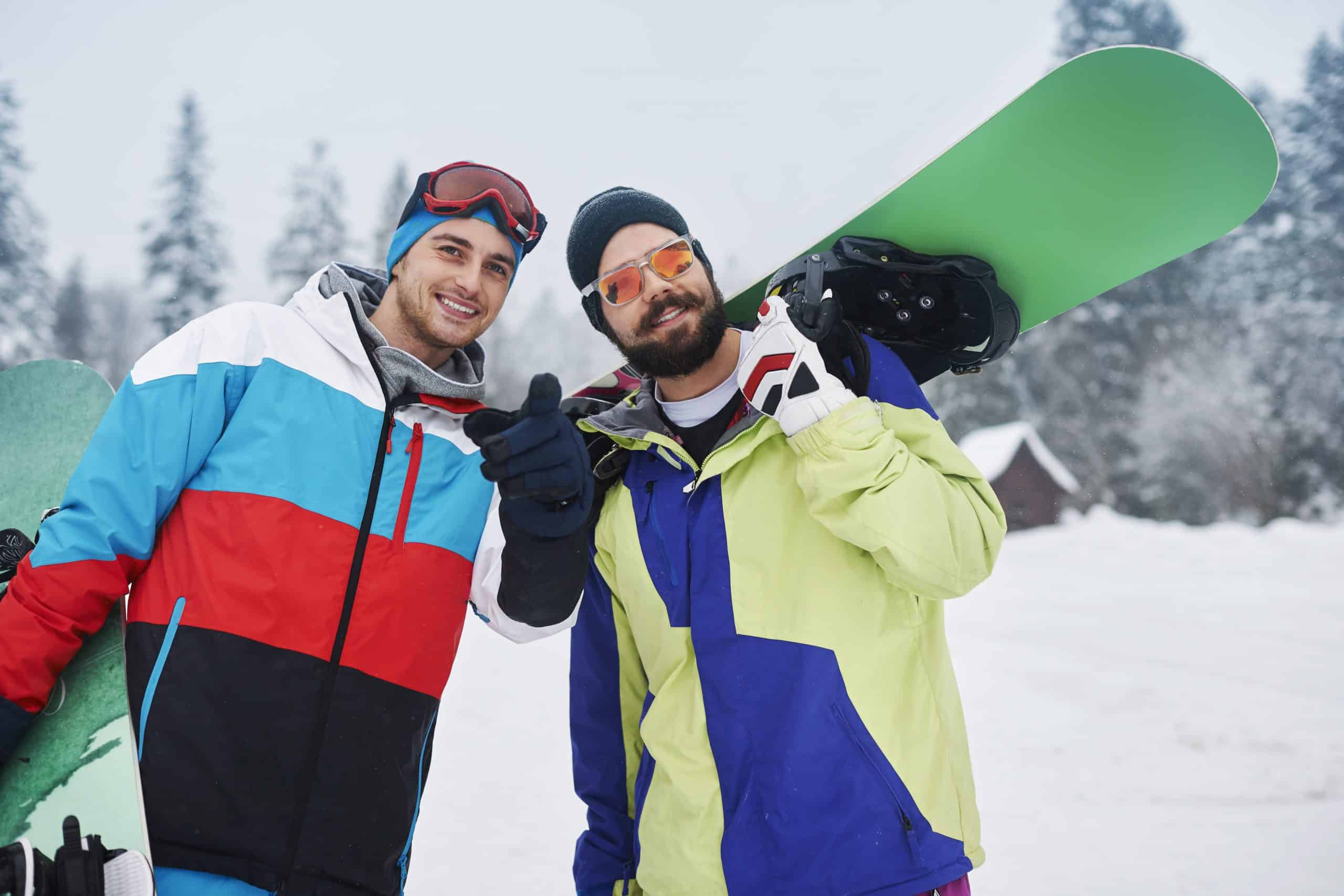 two guys enjoying snowboarding at a bachelor party