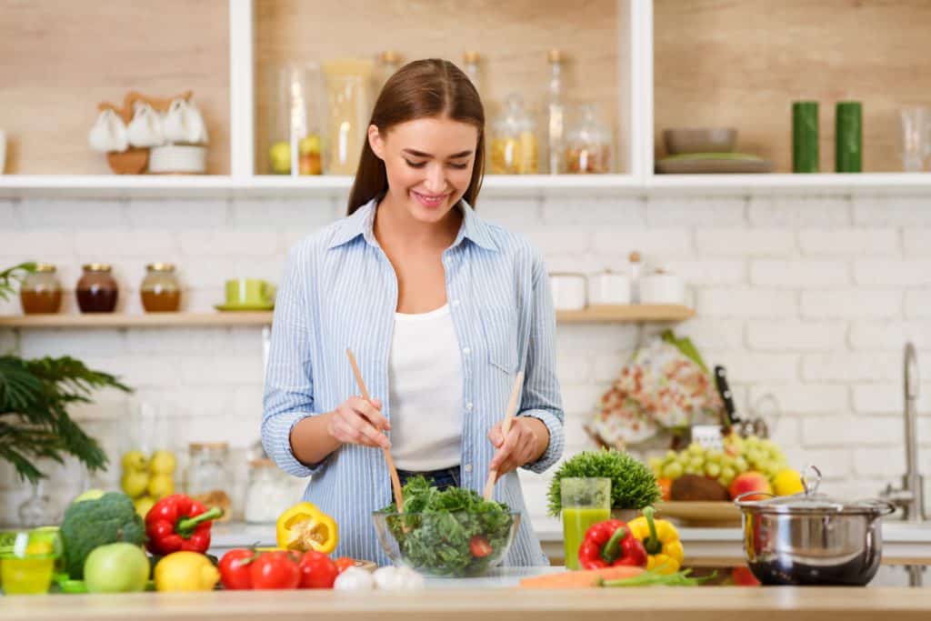 Healthy Eating. Woman Mixing Fresh Salad In Kitchen