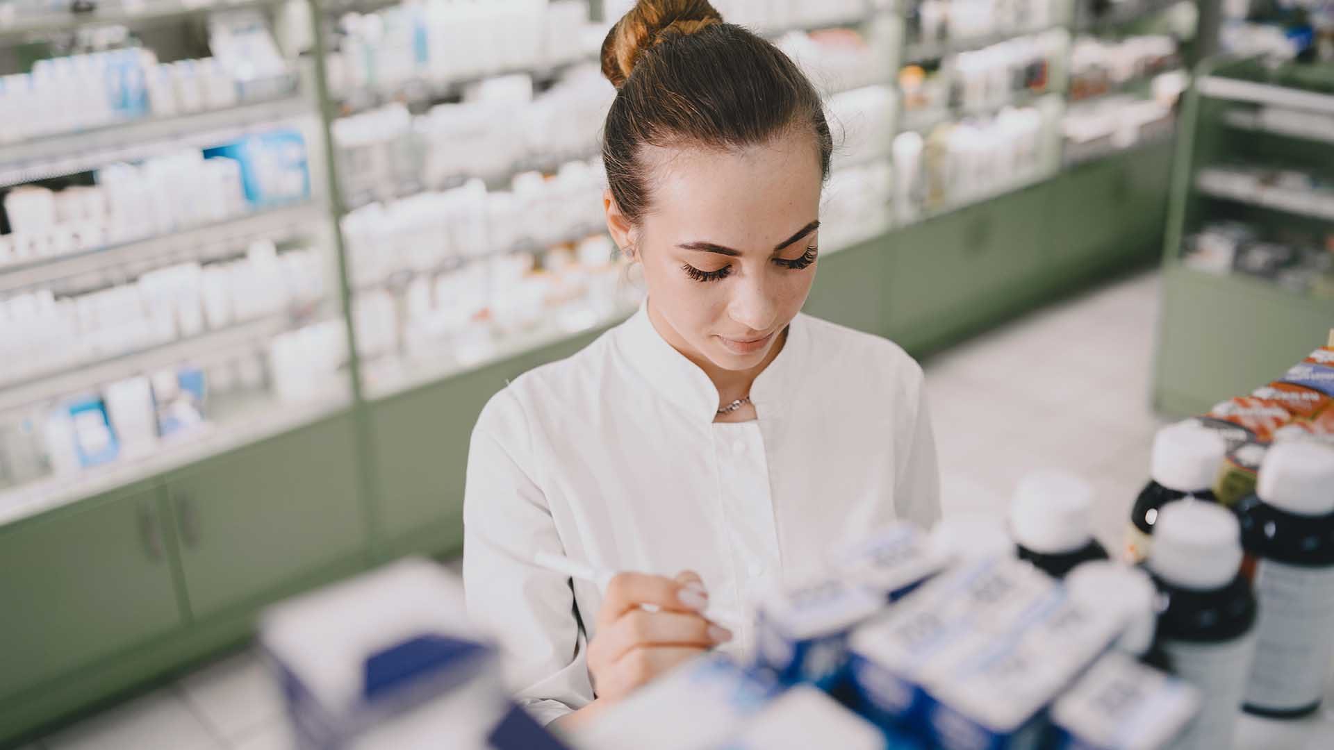 Woman pharmacist checking medicine in pharmacy