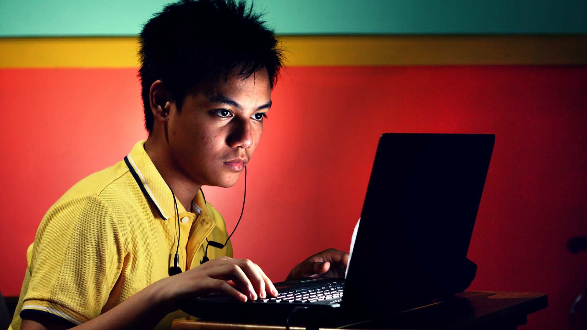teen on his computer
