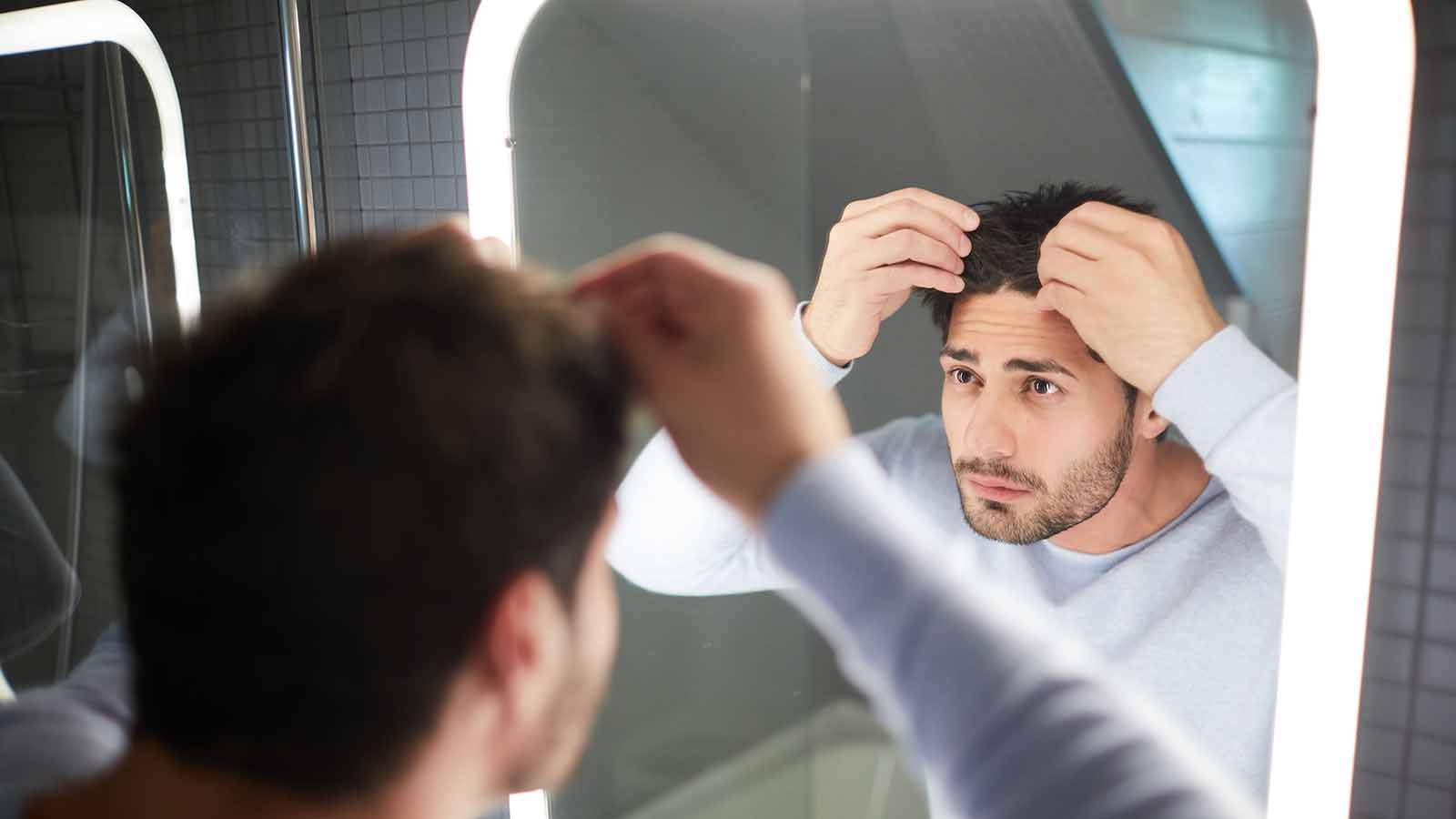 man-checking-for-hair-loss